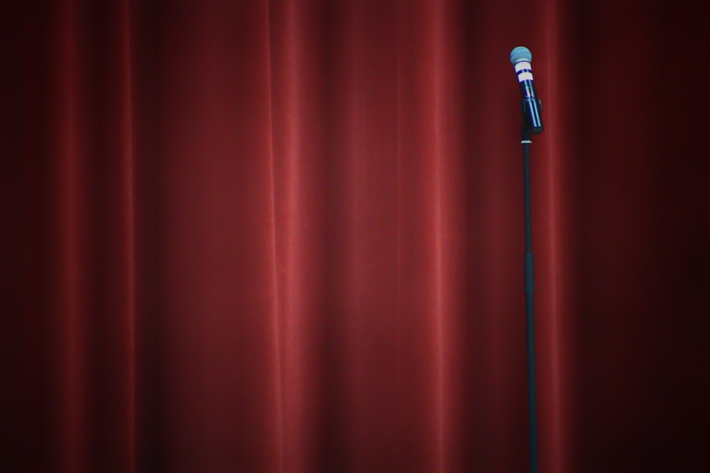 black microphone on red curtain