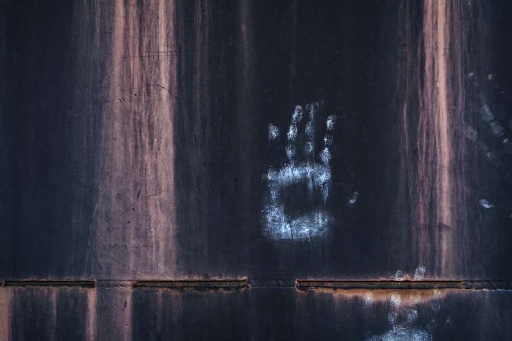 white and black graffiti on brown wooden wall