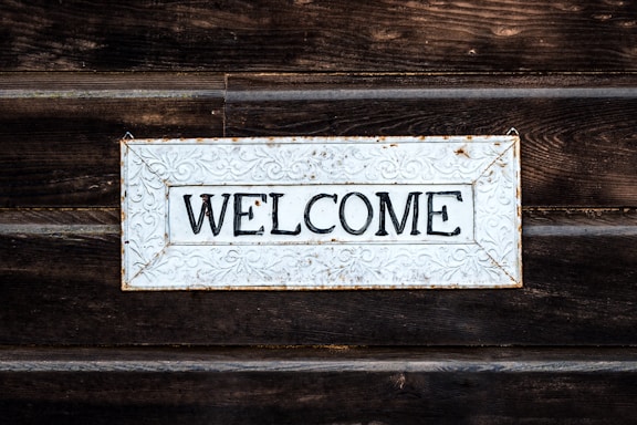 black and white wooden welcome signage