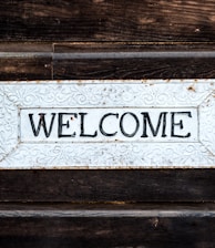 black and white wooden welcome signage