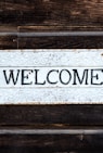 black and white wooden welcome signage