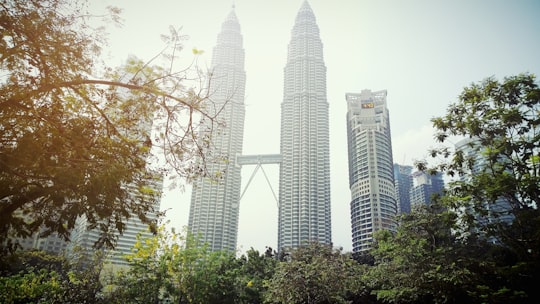 green trees near high rise buildings during daytime in KLCC Park Malaysia