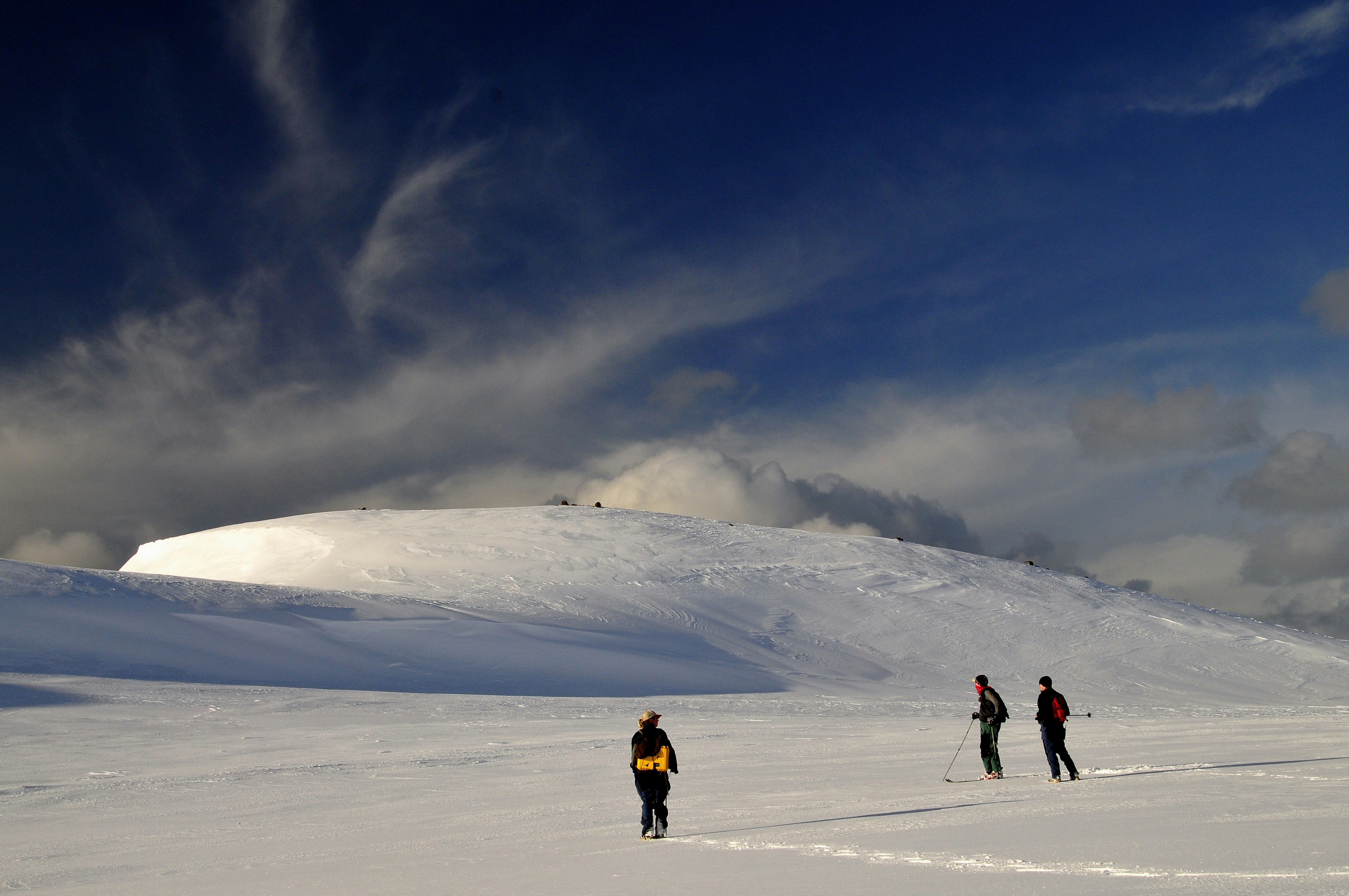 Scientists hiking across a glacier.