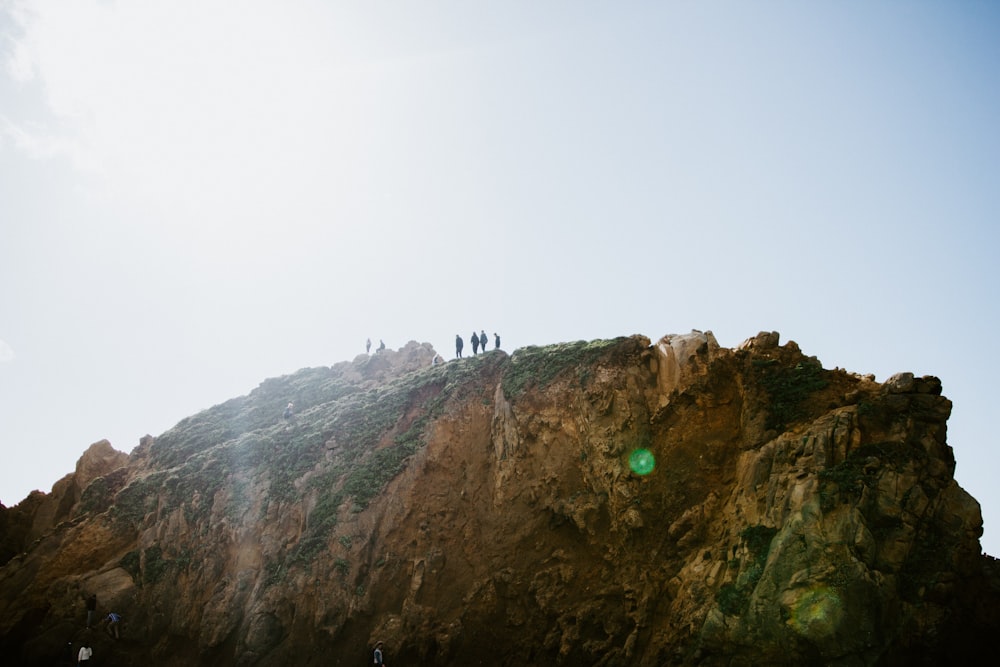 person standing on top of mountain during daytime