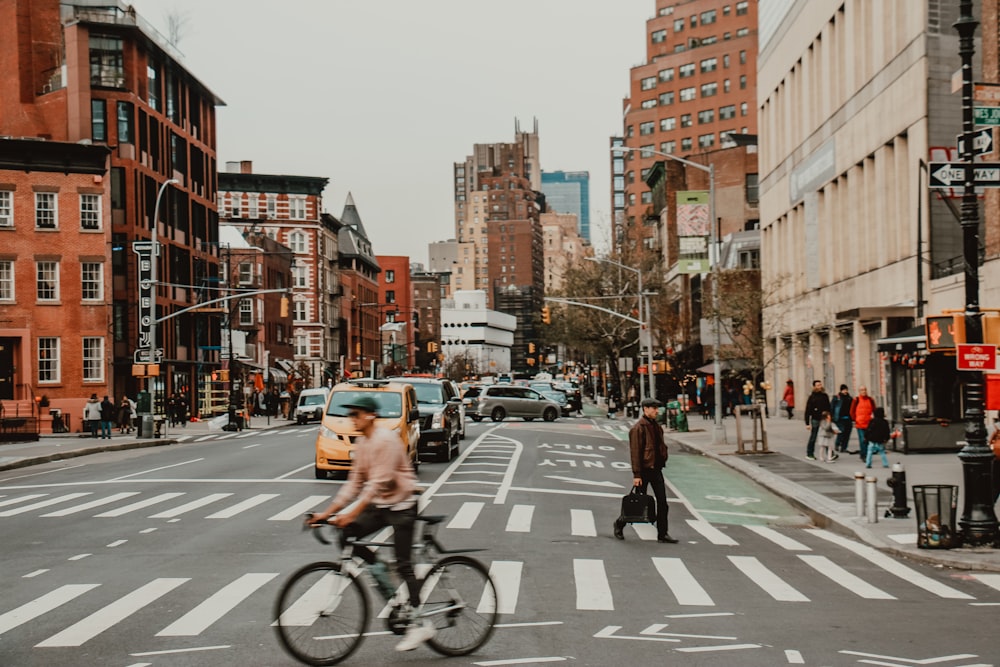 people riding bicycle on road during daytime