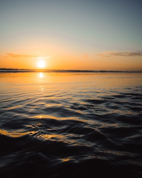 body of water during sunset
