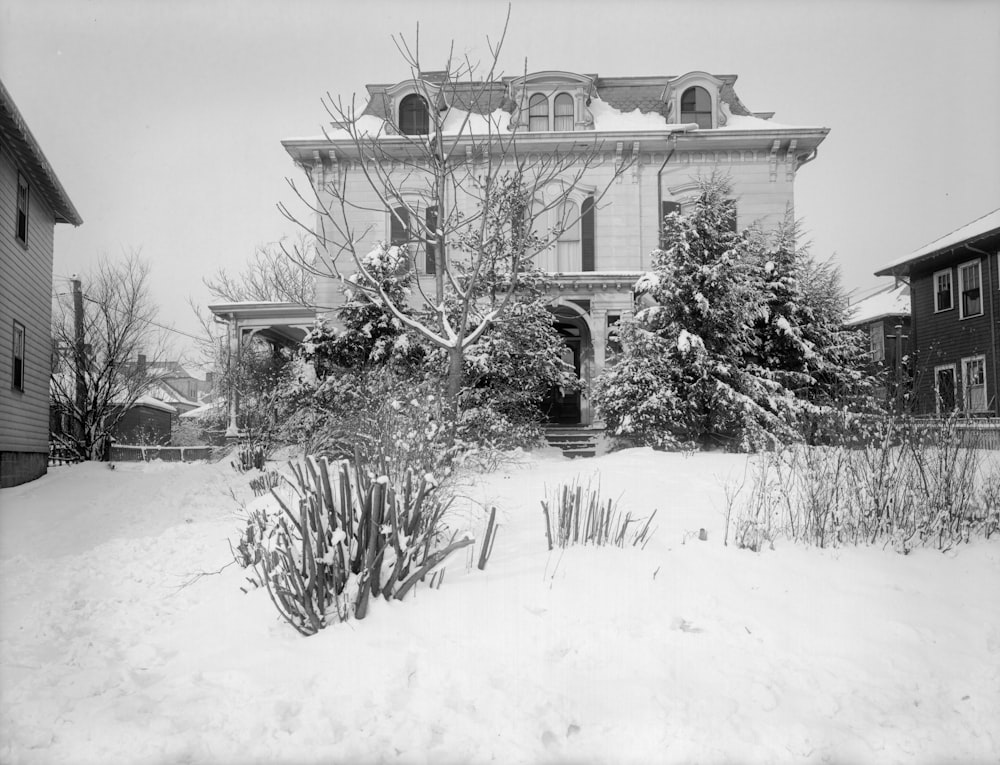 grayscale photo of house covered with snow