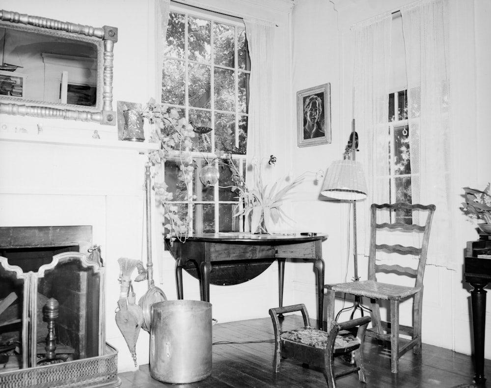 grayscale photo of dining table and chairs