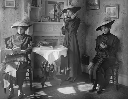 grayscale photo of woman and child sitting on chair