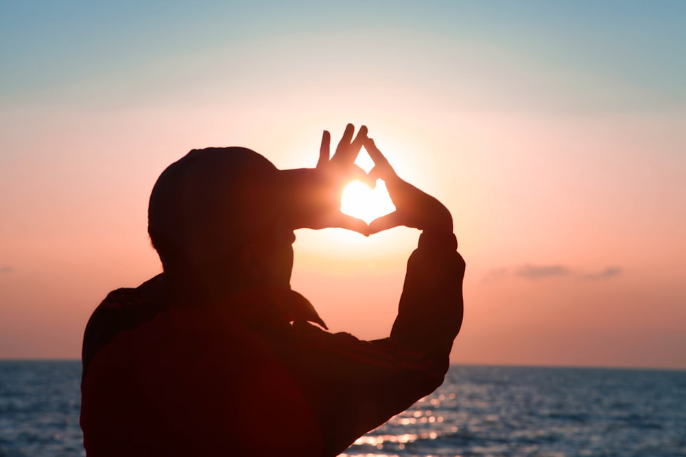 silhouette of man raising his hand