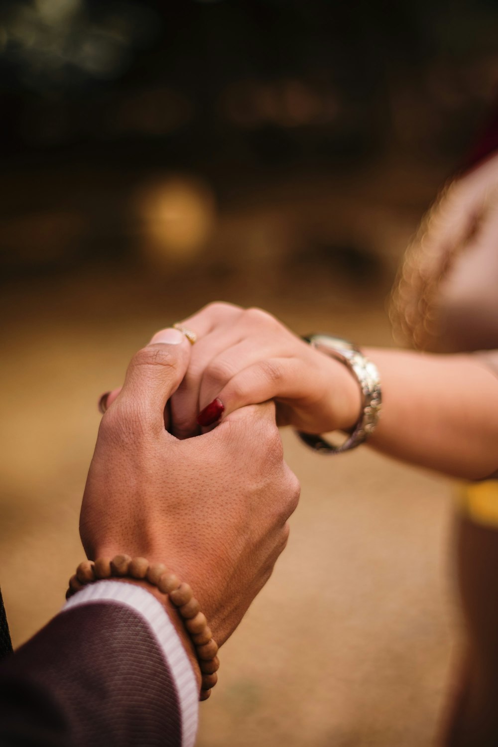 person wearing silver and gold bracelets