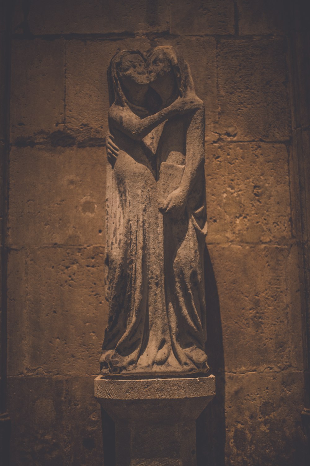 brown concrete statue of a woman