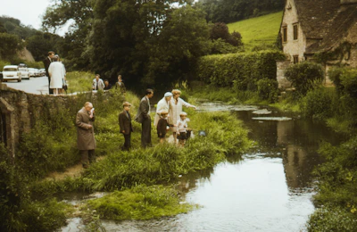Community members gathered by a flowing stream, engaged in water stewardship.