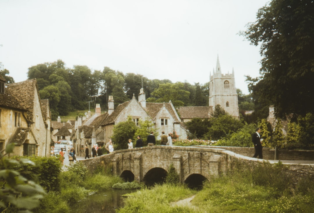 1956 photo of bridge and people in Castle Combe Village, North Wiltshire, UK – Photo by Annie Spratt | Castle Combe England