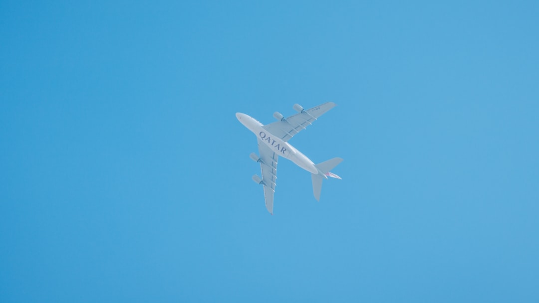 white and blue airplane in the sky