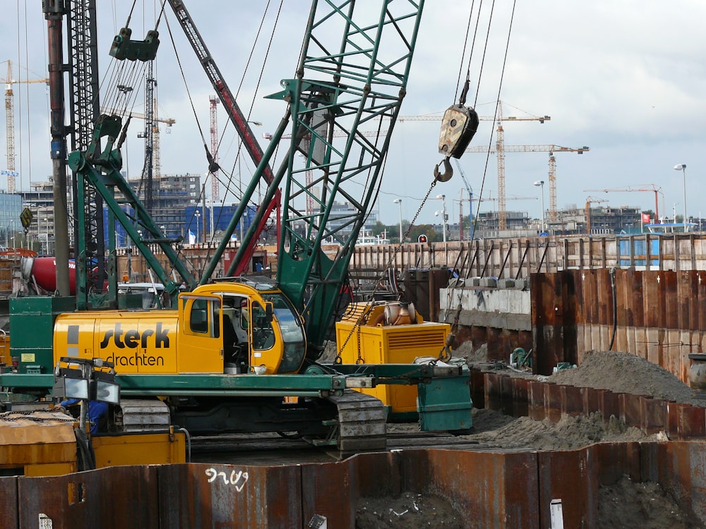 yellow and black crane on brown wooden dock during daytime