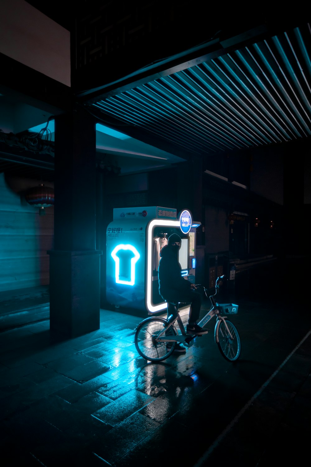 blue bicycle parked beside green building