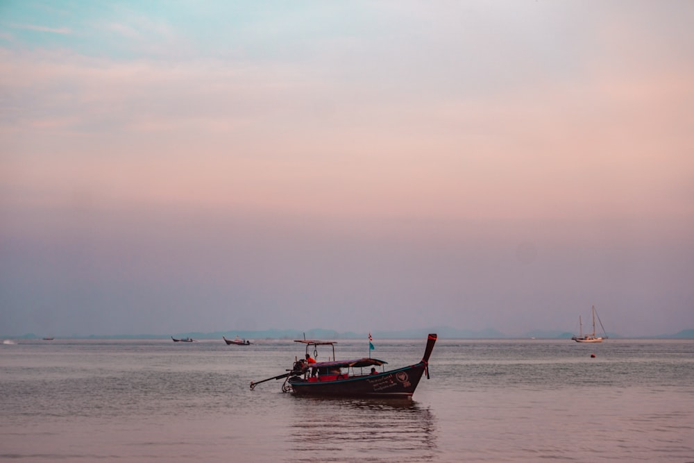 red boat on sea during daytime