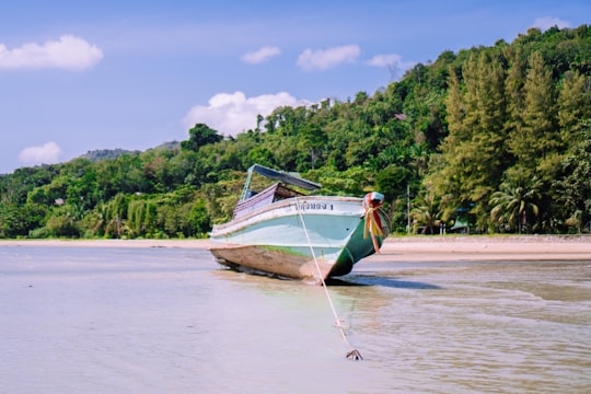 white and brown boat on water during daytime in Ko Yao Noi Ko Yao District Thailand