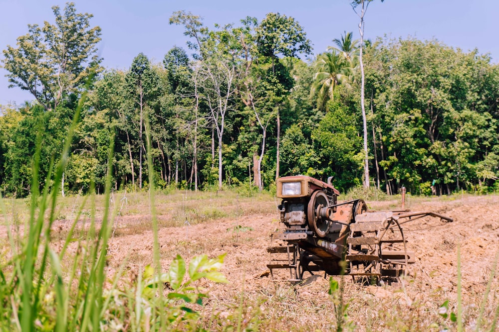 brown tractor on green grass field during daytime