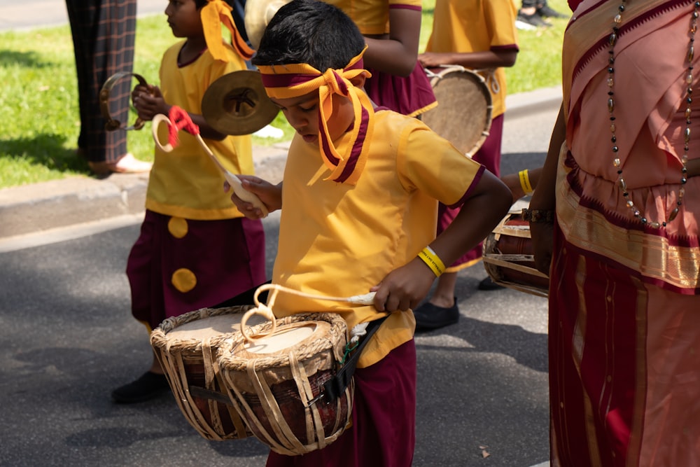 boy in yellow polo shirt playing drum