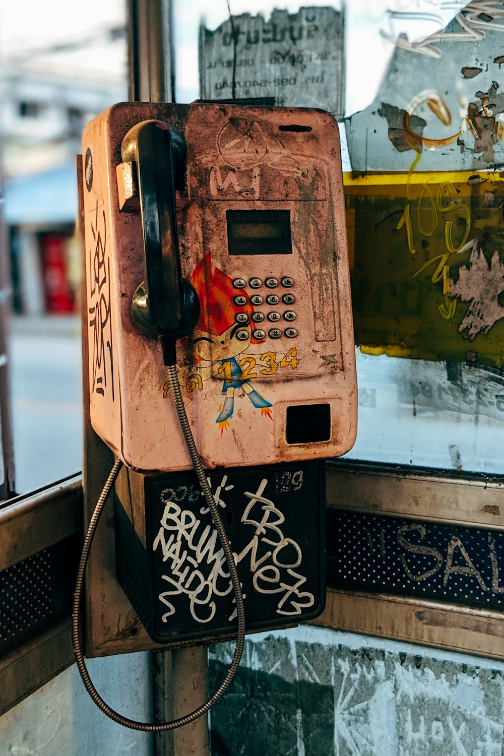 yellow and black telephone booth