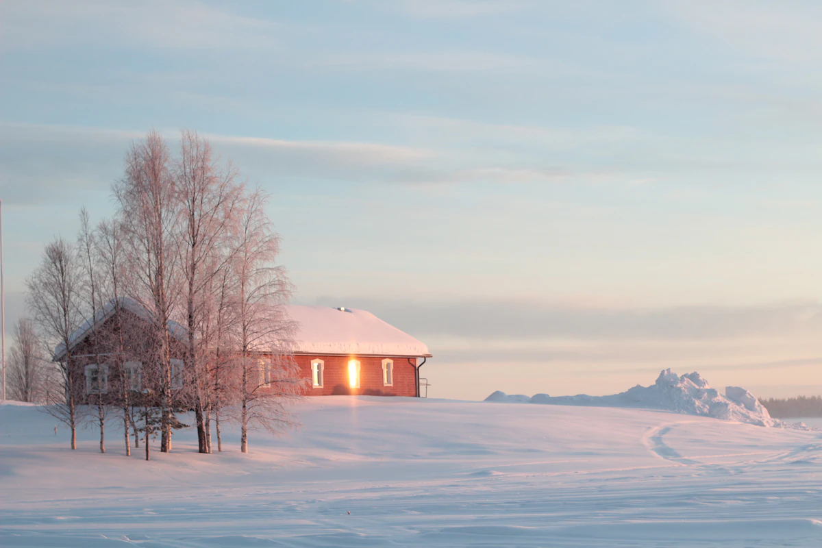 A snow covered wooden cottage in Ylläsjärvi, Finnish Lapland