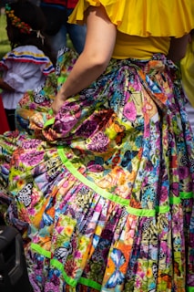woman in yellow pink and blue floral dress