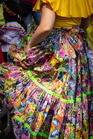 woman in yellow pink and blue floral dress