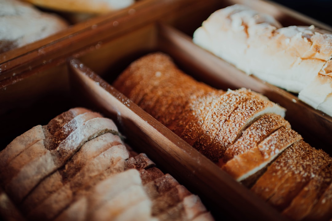 brown and white pastries on brown wooden tray