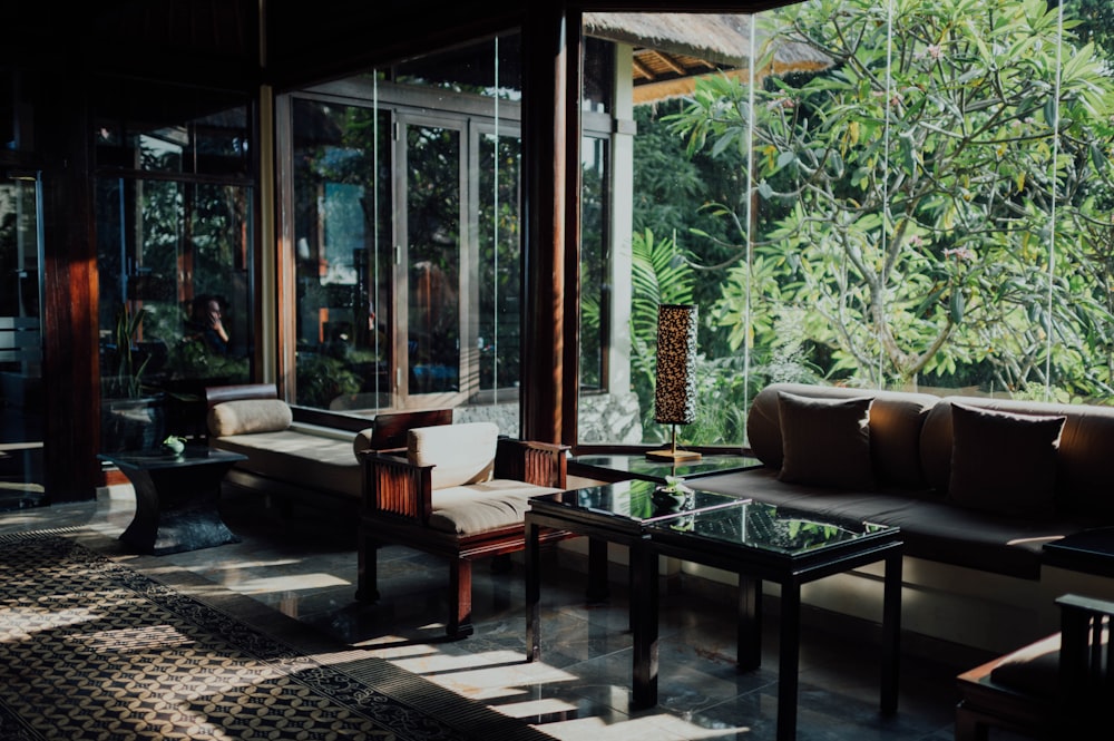 brown wooden table near glass window