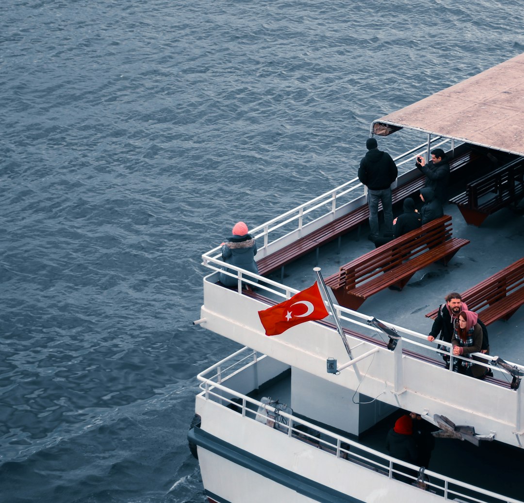 white and red ship on sea during daytime