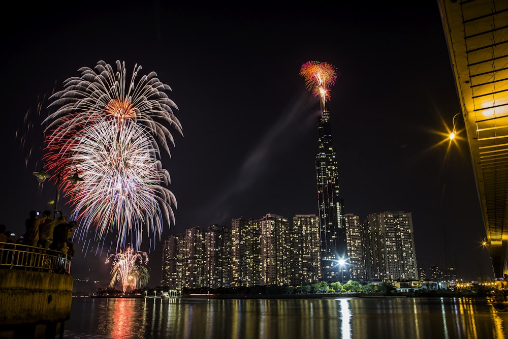 fireworks display over city buildings during night time