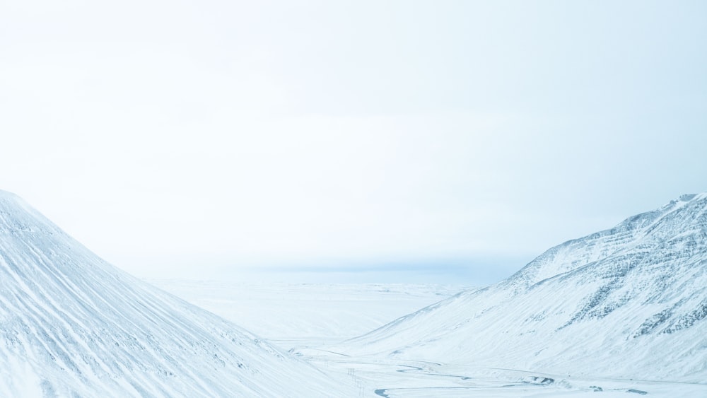 snow covered mountain under white sky during daytime