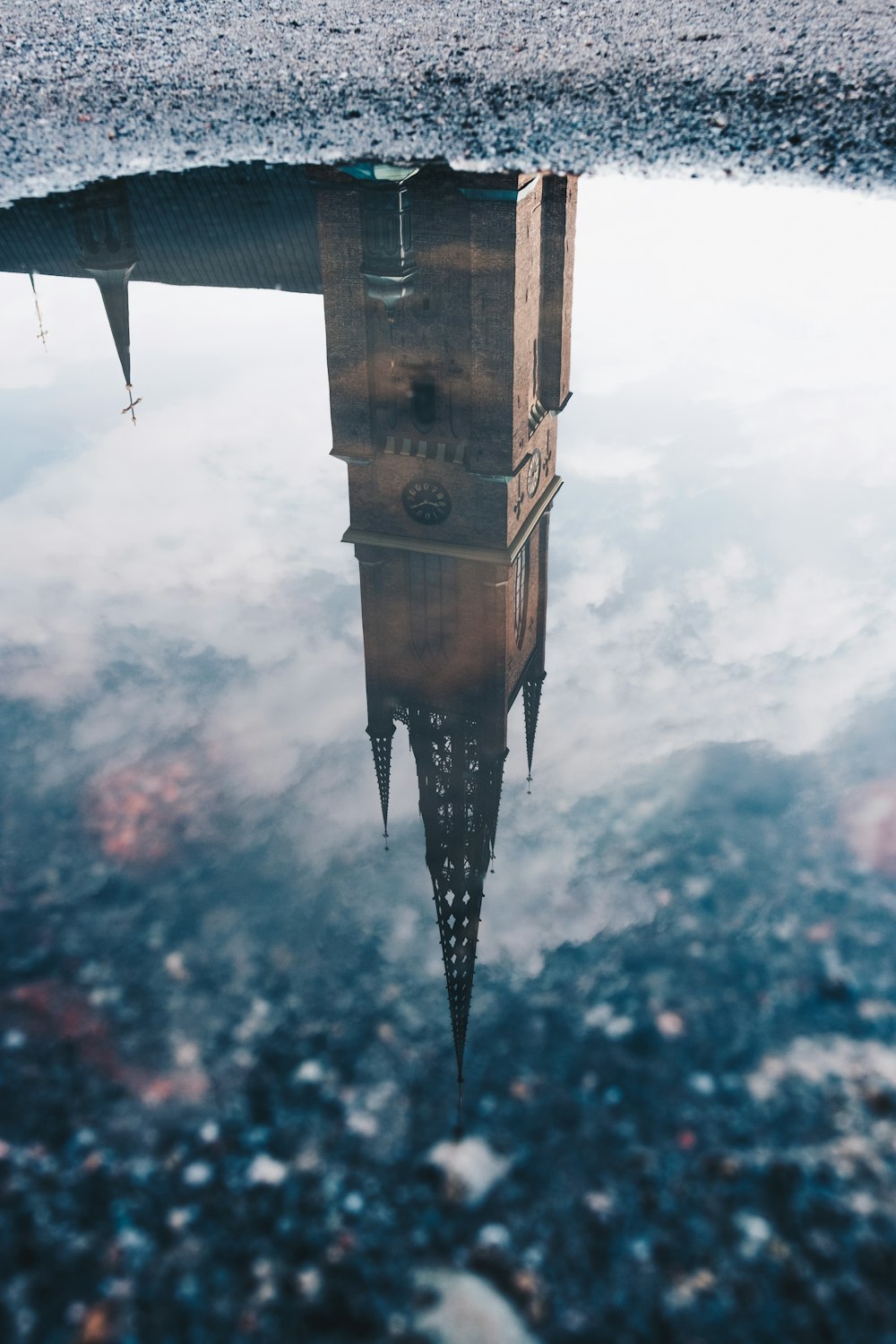 brown and black tower under cloudy sky