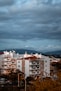 white and brown concrete building under gray sky