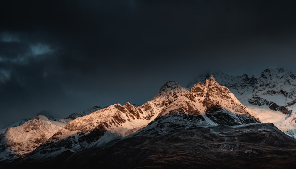 snow covered mountain under blue sky