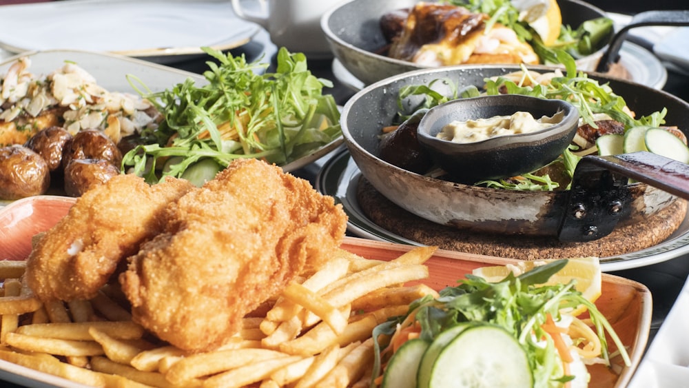 fried chicken and fries on black ceramic bowl