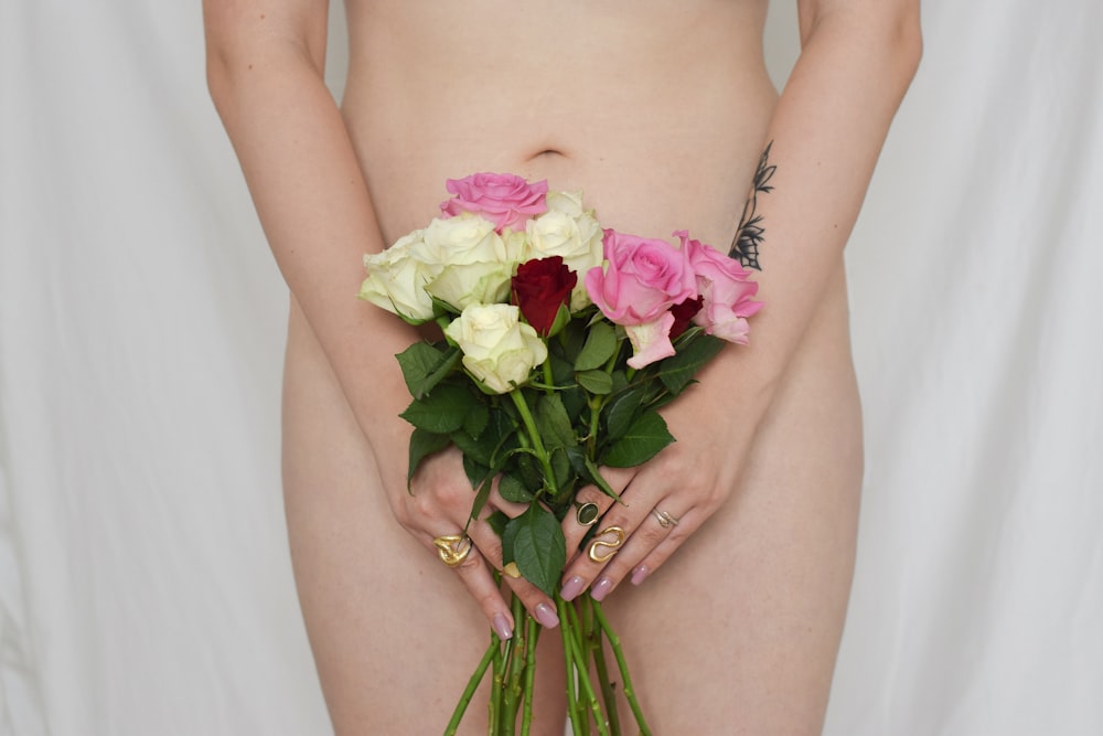 woman holding white and pink rose bouquet