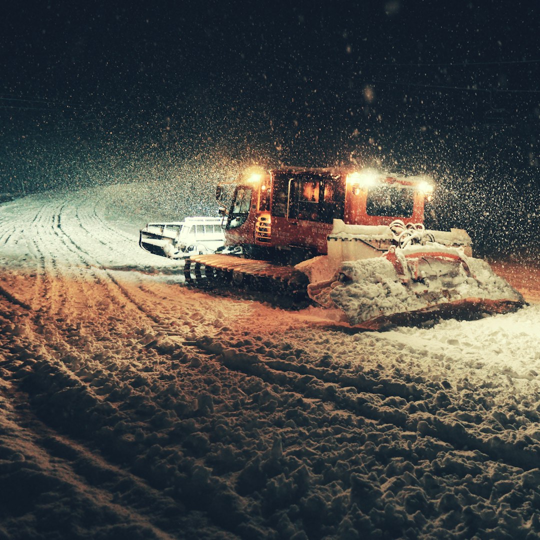 brown truck on snow covered field during night time