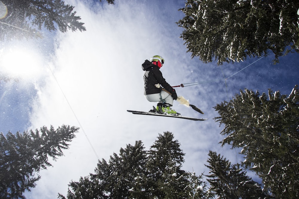 man in red jacket and black pants riding ski blades