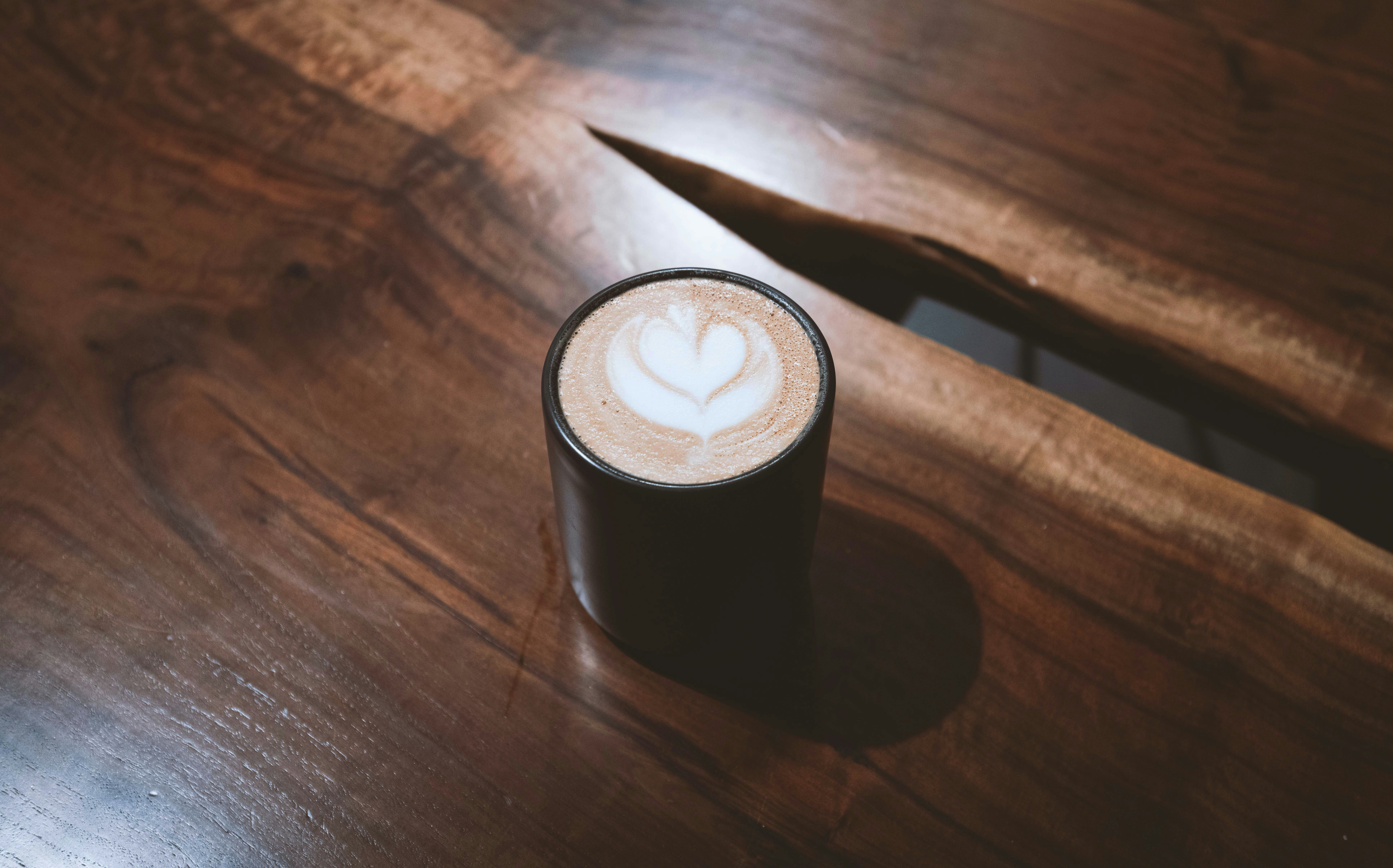 black and white round container on brown wooden table