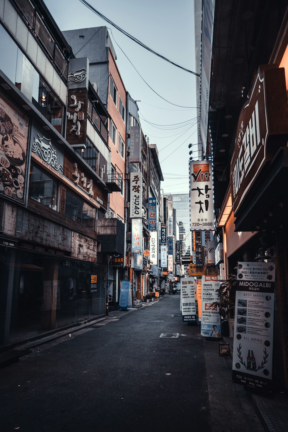 people walking on street between buildings during daytime