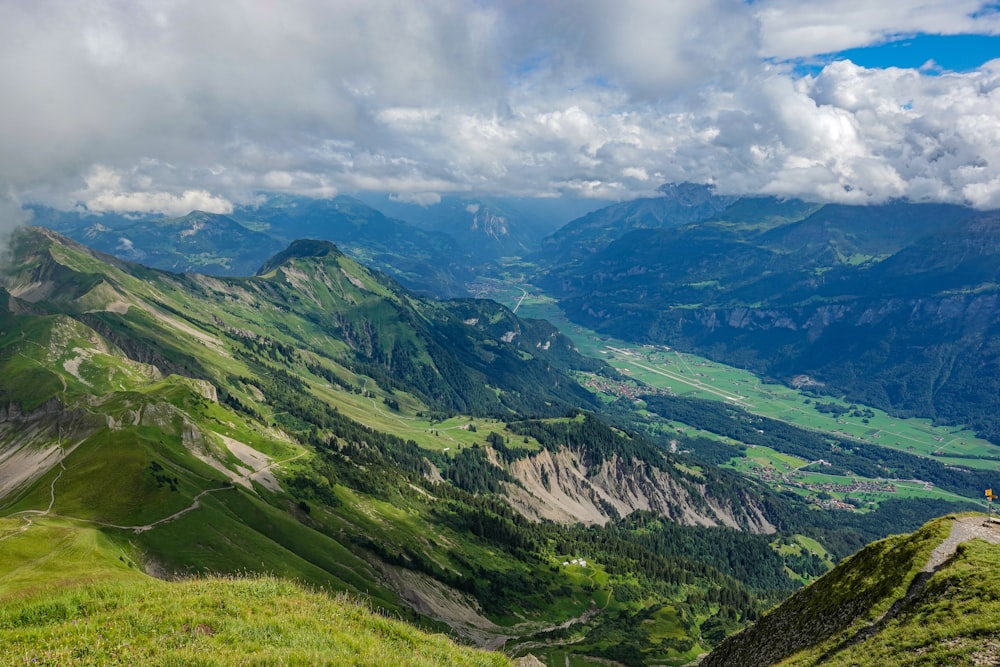 green mountains under white clouds during daytime