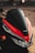A close-up view of a motorcycle's front, featuring a sleek design with a glossy black and red color scheme. The Honda logo is prominently displayed above the headlights.