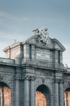 white concrete building with statue of man riding horse