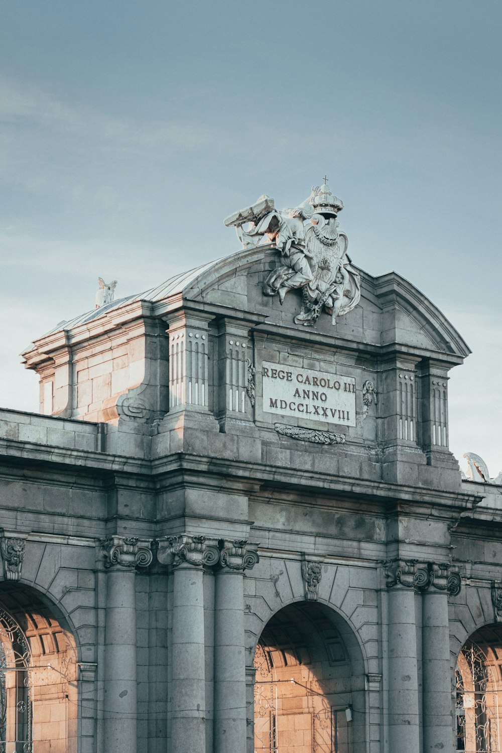 white concrete building with statue of man riding horse