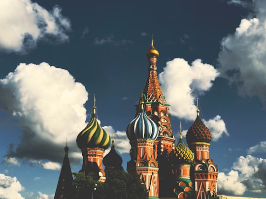 brown and black concrete building under cloudy sky during daytime in St. Basil's Cathedral Russia