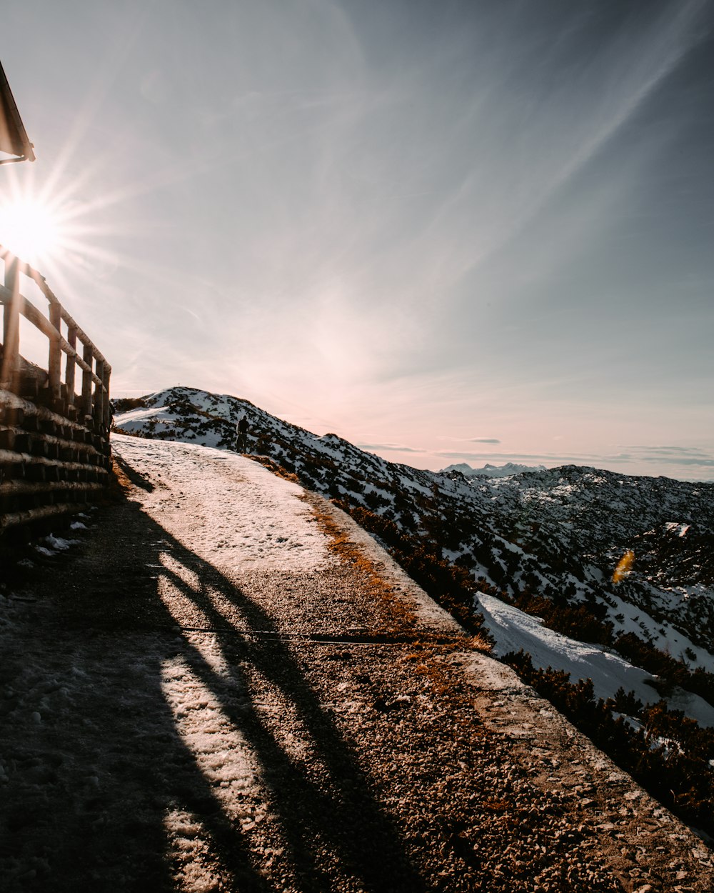 brown wooden fence on snow covered ground during daytime