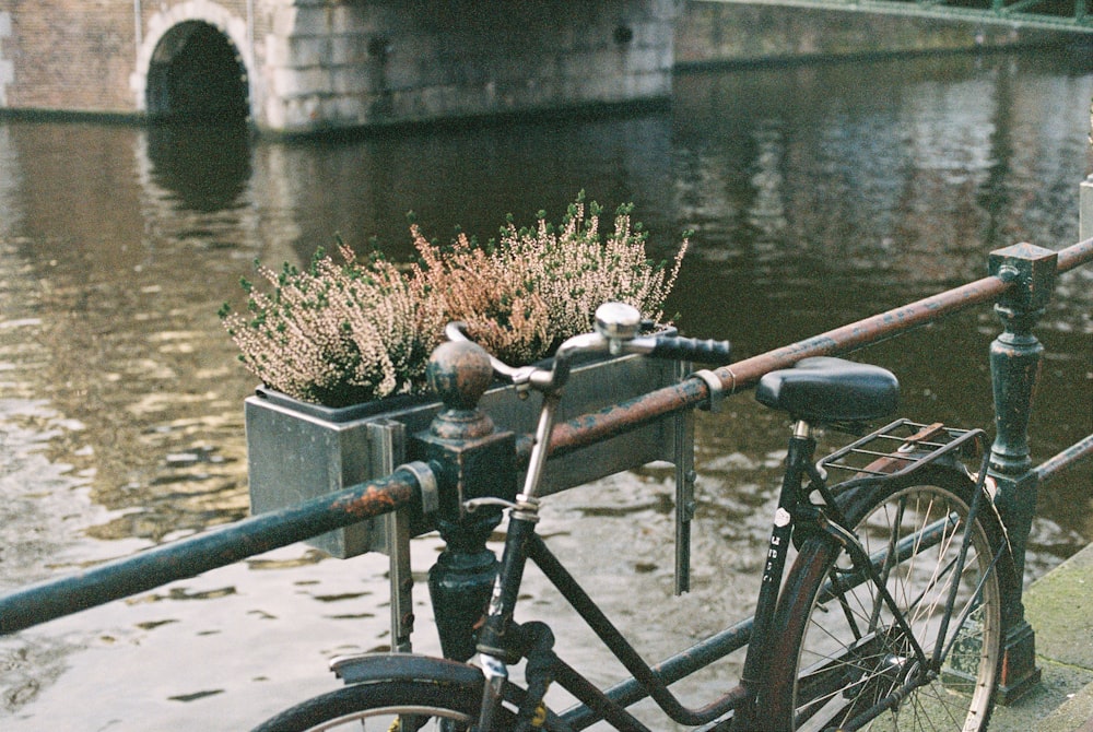 black bicycle beside gray concrete wall